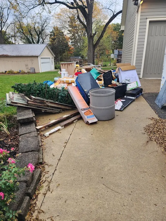 Dumpster being loaded with debris for Roofing Dumpster Rental in Casco